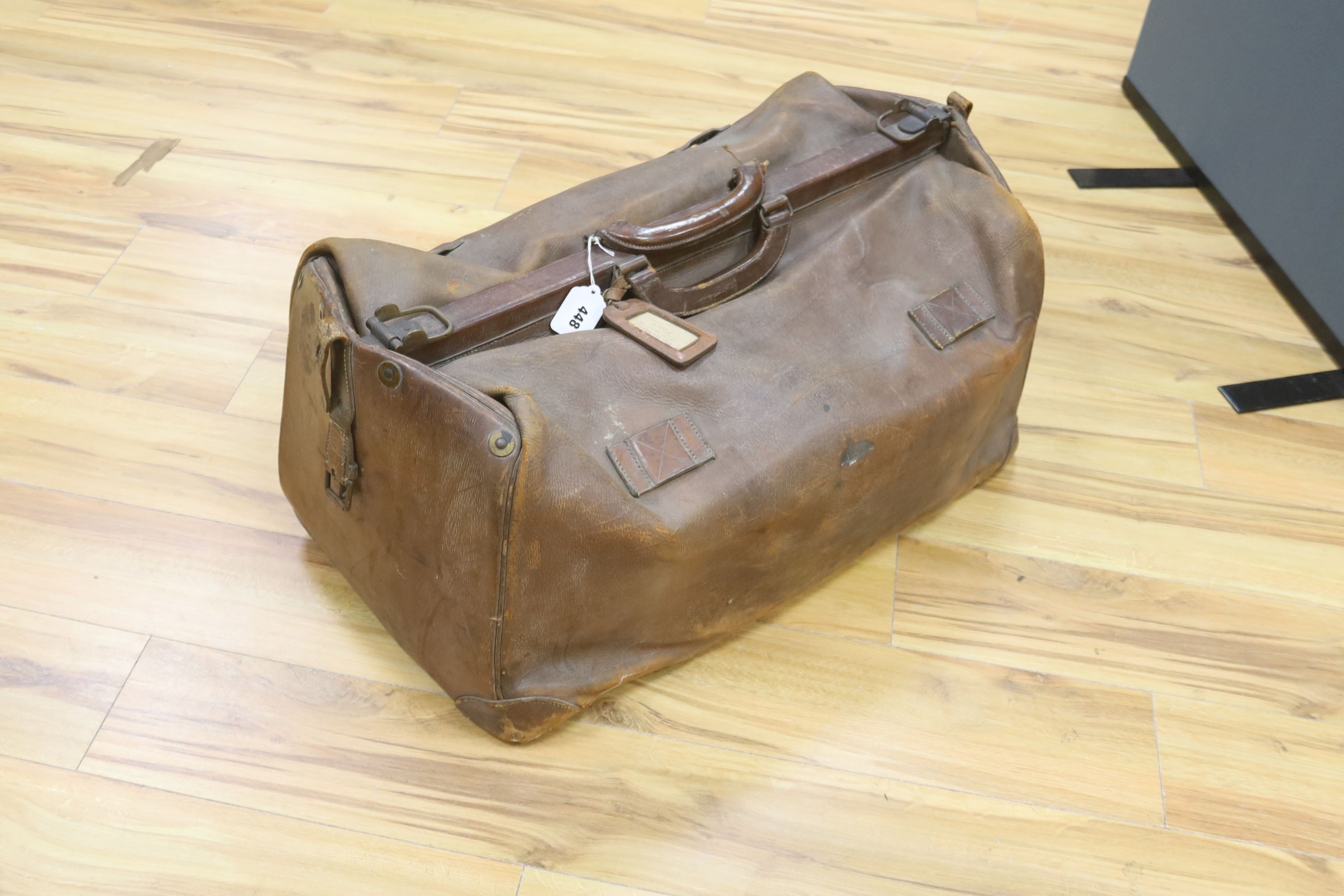 A large Gladstone bag, military canvas contents